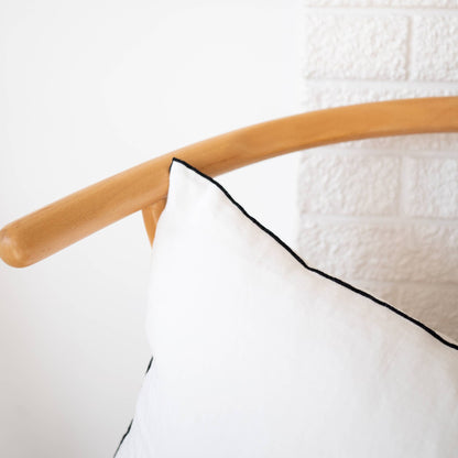 White edged linen lumbar pillow cover styled on a sofa