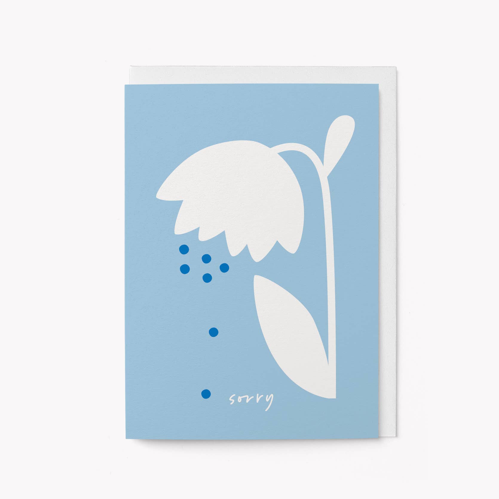 Light blue greeting card with a white illustrated wilting flower and falling dots, with the word 'sorry' written in script