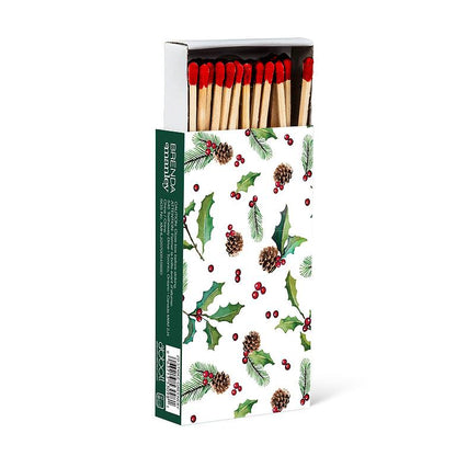 Long wooden matches in a green box illustrated with holly, pinecones, and berries, red-tipped matchsticks