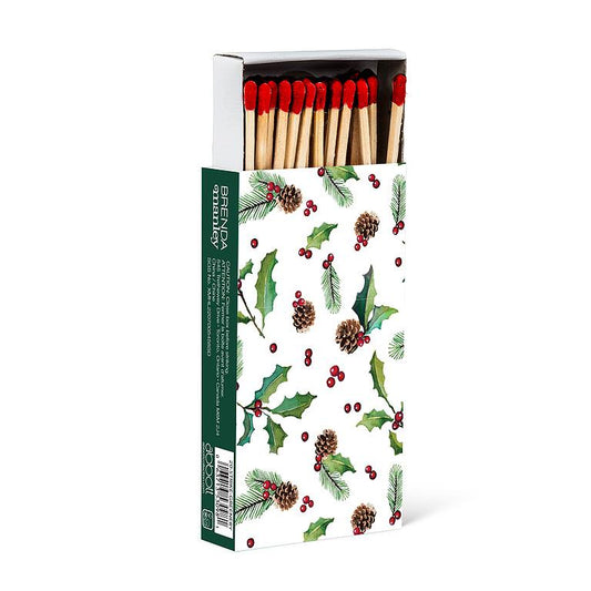 Long wooden matches in a green box illustrated with holly, pinecones, and berries, red-tipped matchsticks