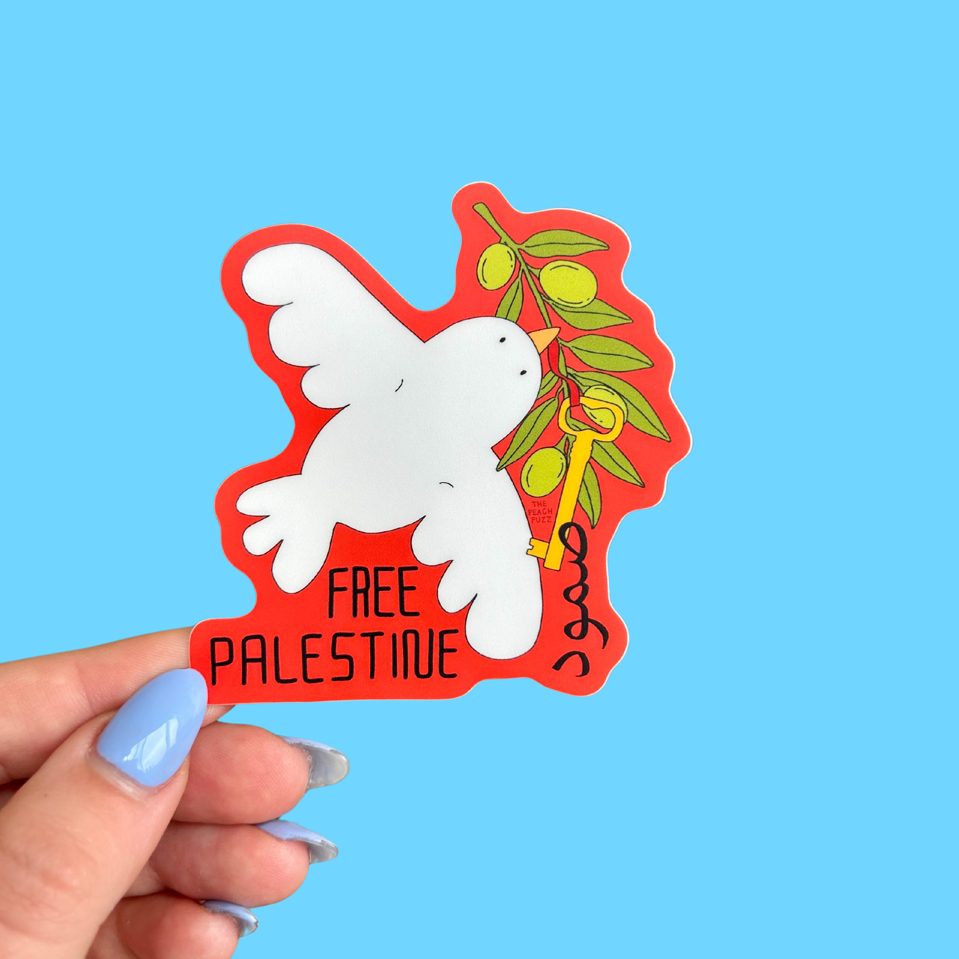 White dove carrying an olive branch and gold key on a red background, reading Free Palestine with Arabic text