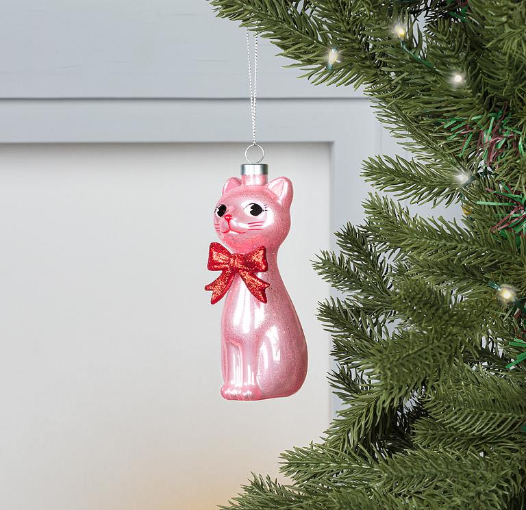 Side view of the pink glass Retro Cat Ornament showing its silhouette and shine.