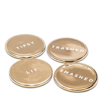 Set of four gold ceramic coasters printed with the words Tipsy, Lit, Trashed, and Smashed