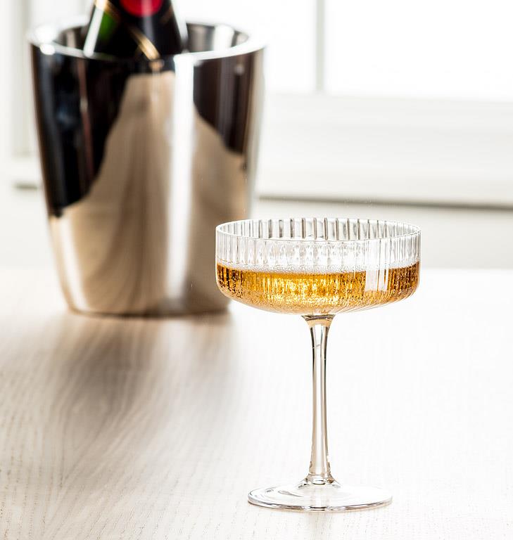 Clear glass cocktail coupe with fine optic ribbing, additional angle