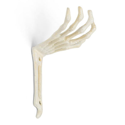 Cast iron wall hook shaped like a skeletal hand reaching outward, antique white finish, photographed against a plain background.