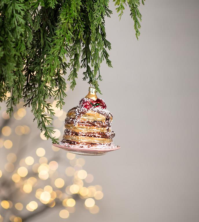Close-up of the glass pancake stack ornament showing glittery syrup and sugar detail.
