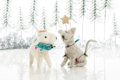 Close-up of the felted cat ornament's face and string light detail.