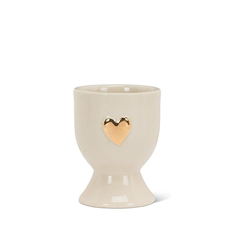 Ivory and gold stoneware egg cup shaped like a heart, 2.5 inches tall
