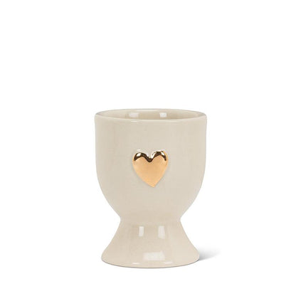 Ivory and gold stoneware egg cup shaped like a heart, 2.5 inches tall