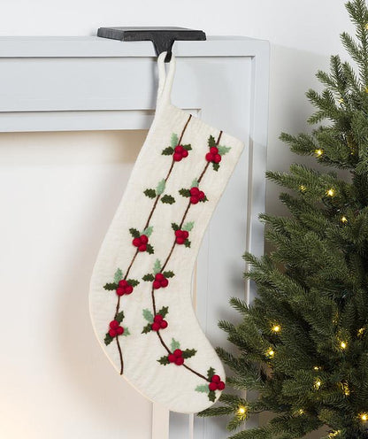 Close-up detail of the felted holly and berry embroidery on the stocking.
