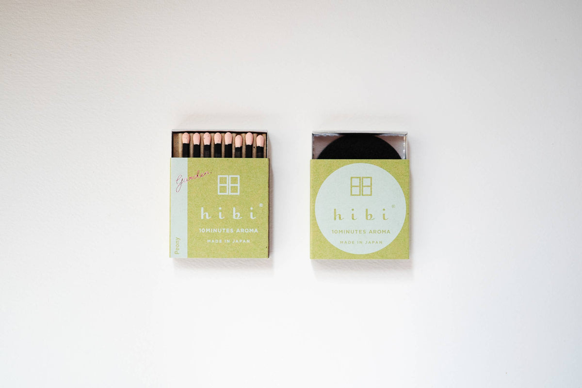 Hibi Peony incense matches in a pale yellow-green box with pink match heads, open beside a closed box - PABOOM