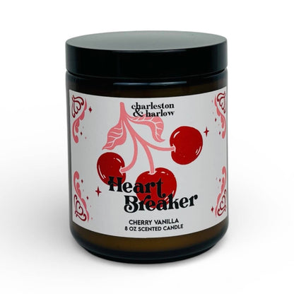 Charleston & Harlow Heart Breaker soy candle in amber glass jar with cream label featuring illustrated cherries