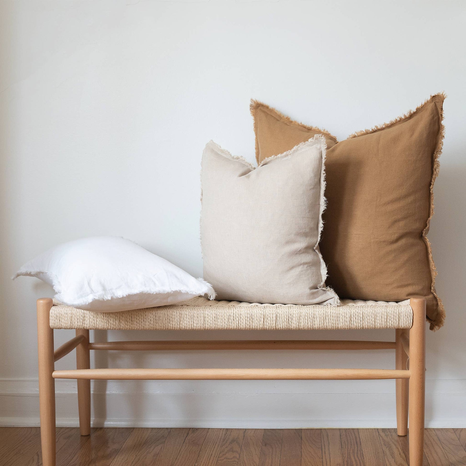 Back of the white fringed linen lumbar pillow cover showing the closure