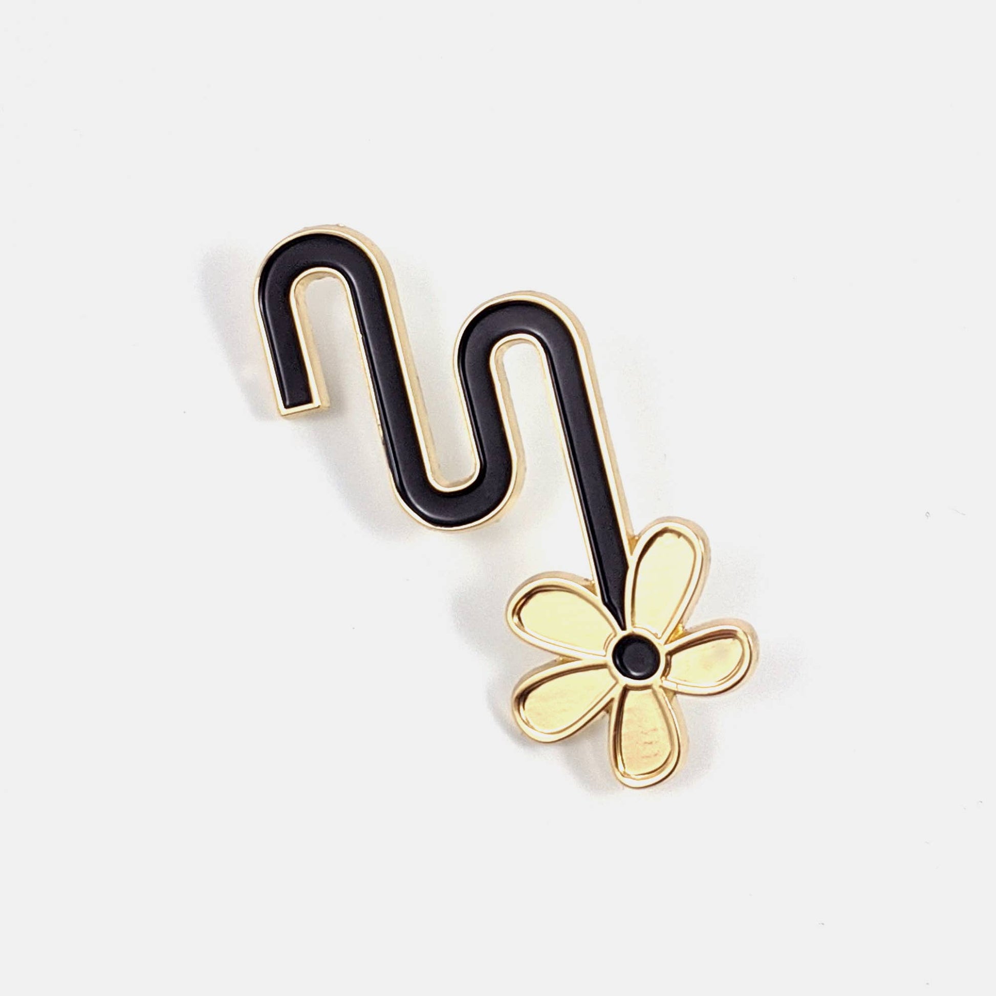 Black and gold enamel pin of a flower hanging from an S-curved stem - PABOOM