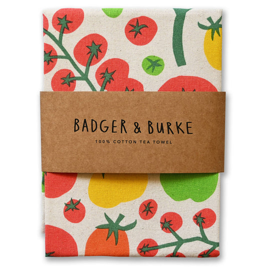 Folded natural cotton tea towel printed with red vine tomatoes and yellow and green heirlooms, Badger + Burke kraft band - PABOOM