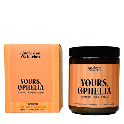 Charleston & Harlow Yours, Ophelia soy candle in amber glass jar with orange striped label, beside its matching gift box