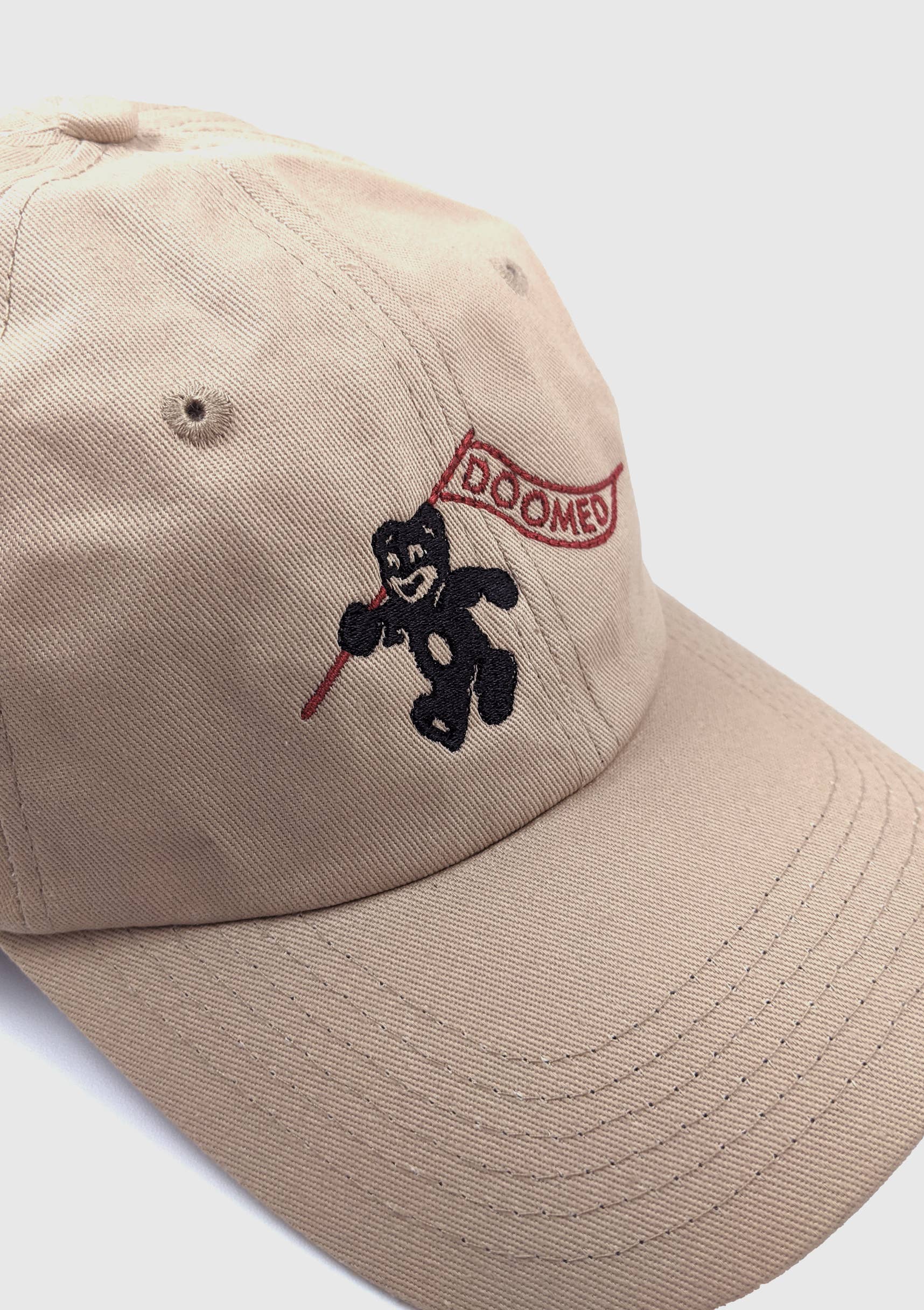 Side view of Doomed tan dad hat showing adjustable metal clasp - PABOOM