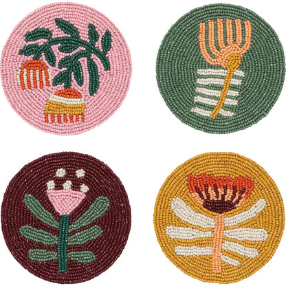 Four round hand-beaded coasters in pink, green, burgundy, and mustard with botanical flower and leaf designs – PABOOM