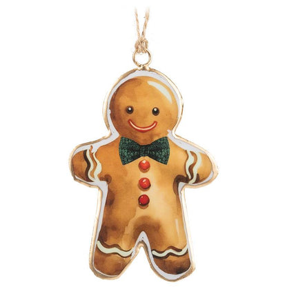 Glossy metal gingerbread man ornament with a painted smiling face, green bow tie, and red button details, hanging from a jute string.