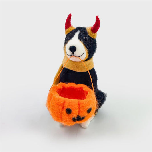 Felted black and white dog ornament wearing red devil horns and an orange scarf, holding a jack-o'-lantern bucket - PABOOM