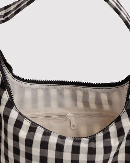 Interior view of the BAGGU Nylon Shoulder Bag in black and cream gingham showing the zip pocket