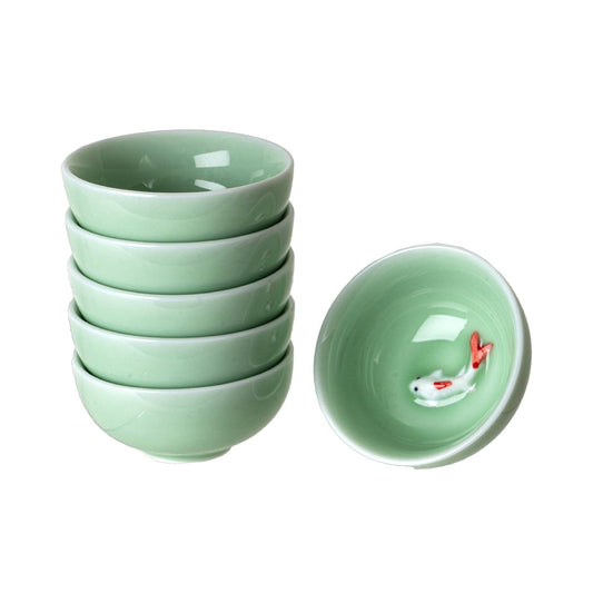 Stack of celadon green porcelain tea cups with a koi fish inside one - PABOOM