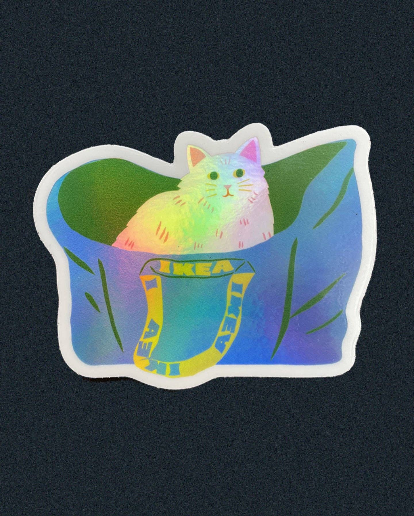 Holographic sticker of a fluffy cat peeking out of a blue IKEA tote bag with leafy greens - PABOOM
