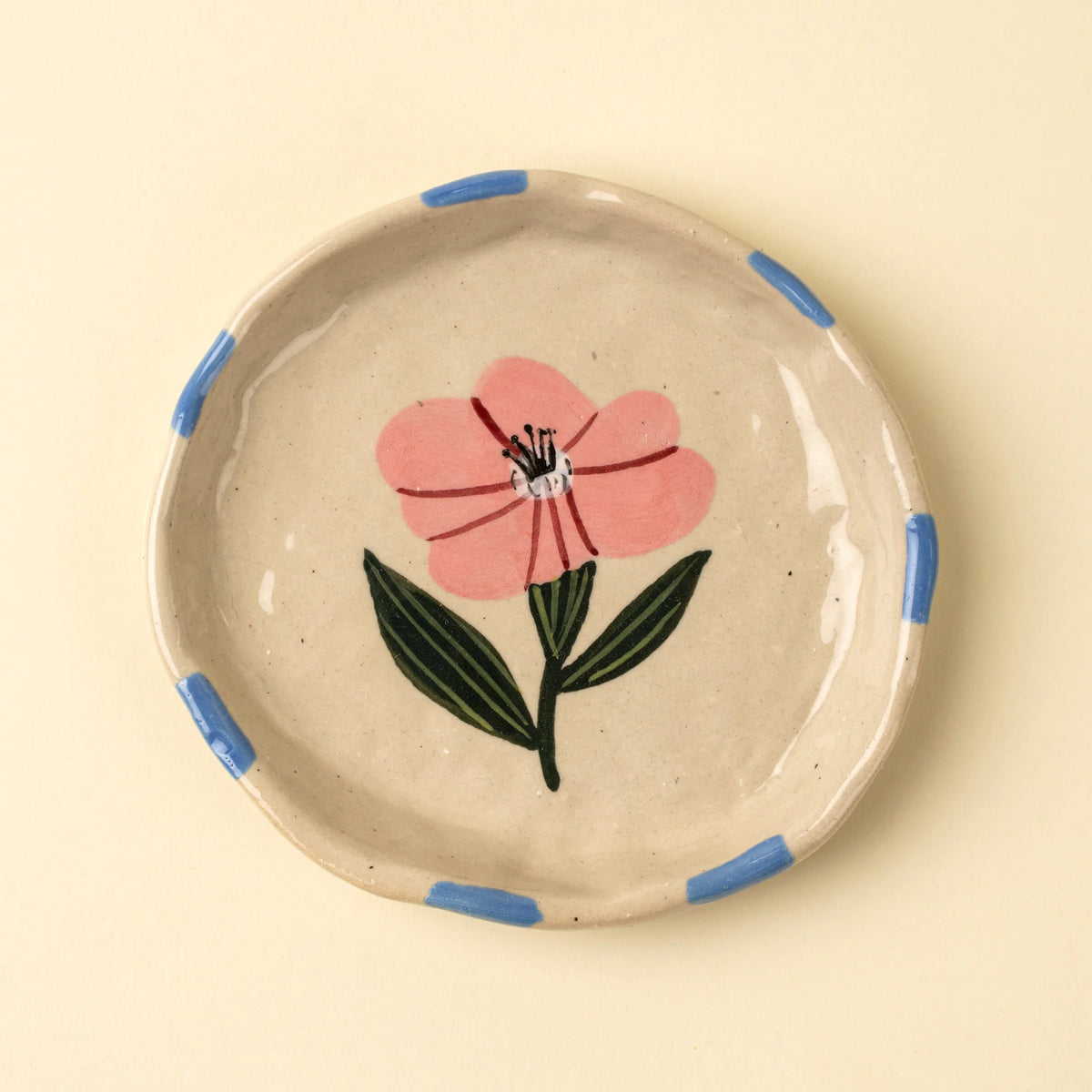 Small cream stoneware dish hand-painted with a pink and blue floral design