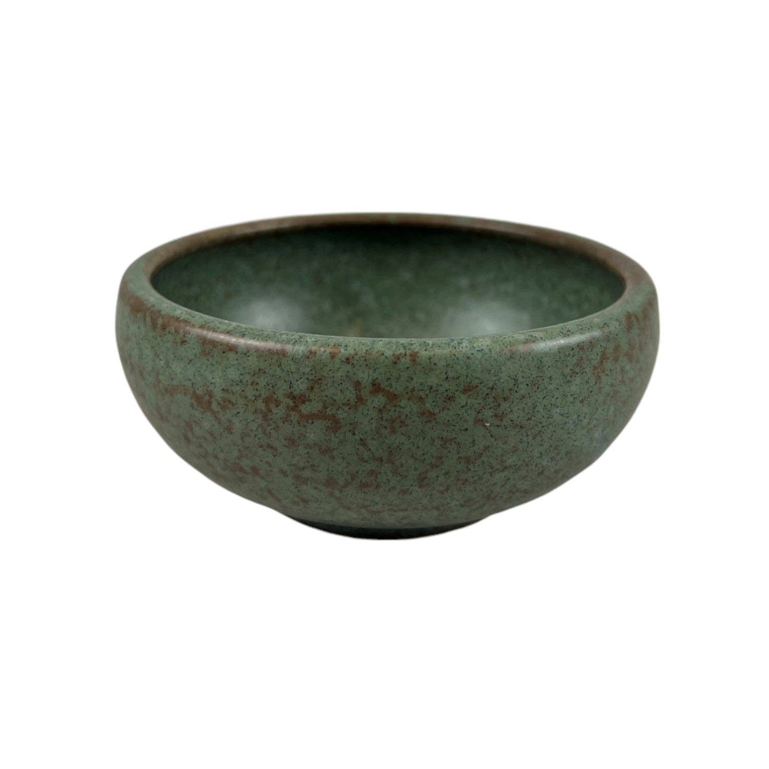 Speckled sage green matte porcelain shallow bowl viewed from a front angle