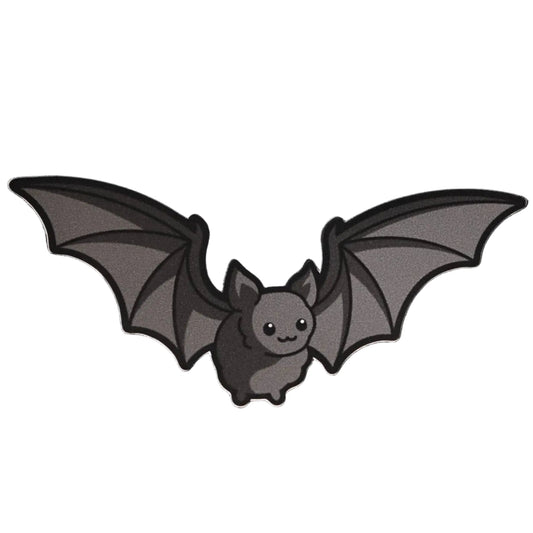 Grey vinyl die-cut sticker of a cute cartoon bat with wide-spread wings and a smiling face on a white background
