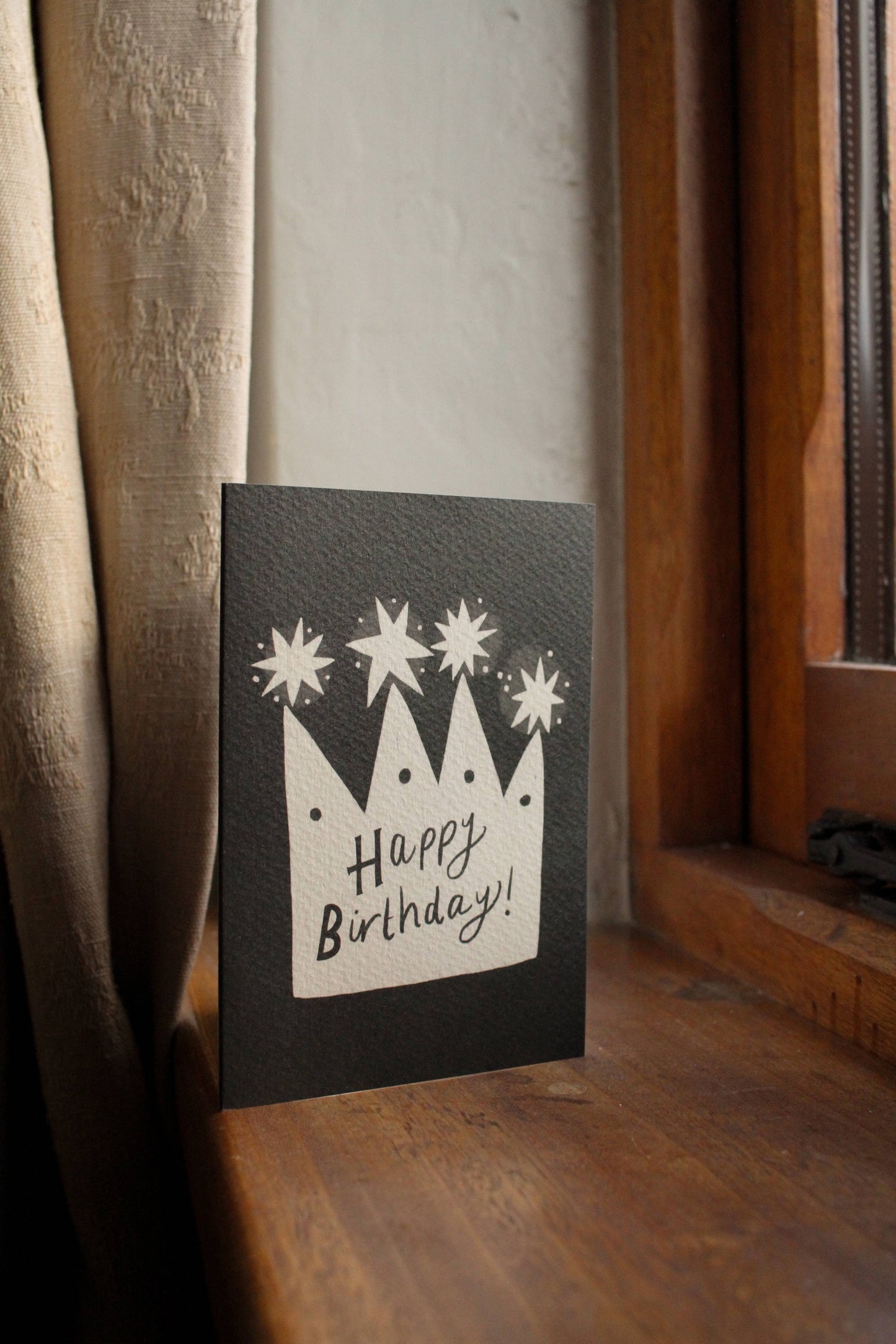 'Happy Birthday Crown' card propped against its kraft envelope, showing the full illustrated design