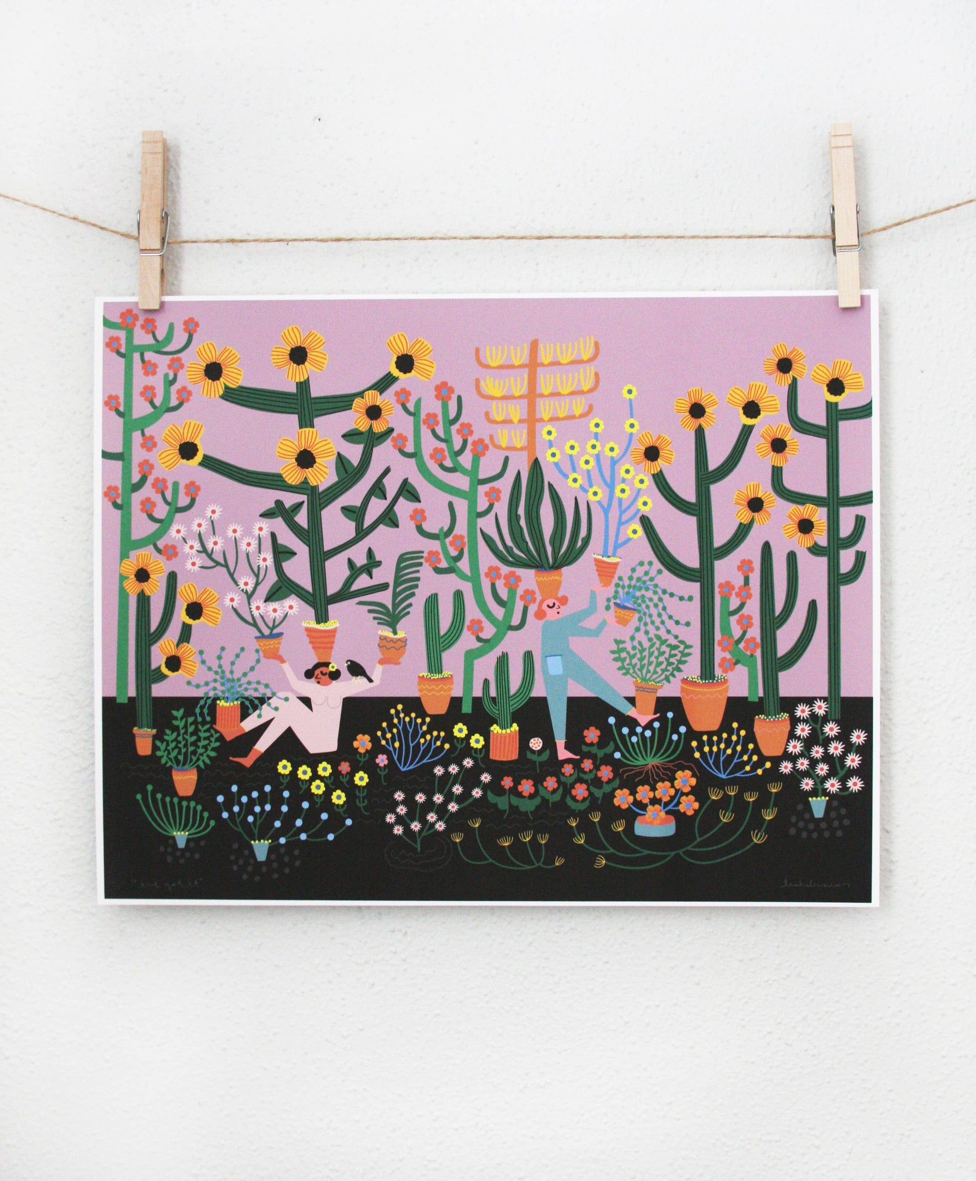 Archival print of two figures gardening among sunflowers and potted succulents on a lavender and black background, clipped to a string — PABOOM