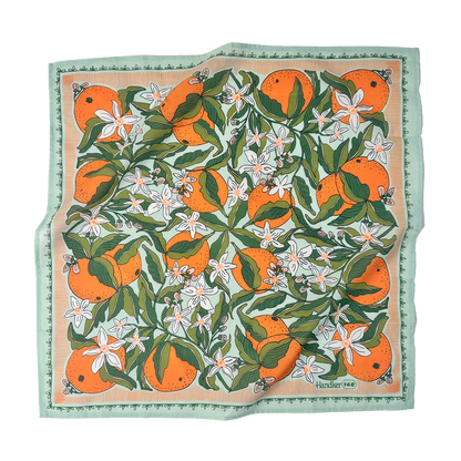 Zoe Bandana flat lay showing the citrus-orange painted print