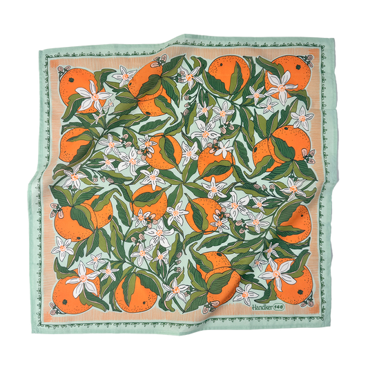 Zoe Bandana flat lay showing the citrus-orange painted print