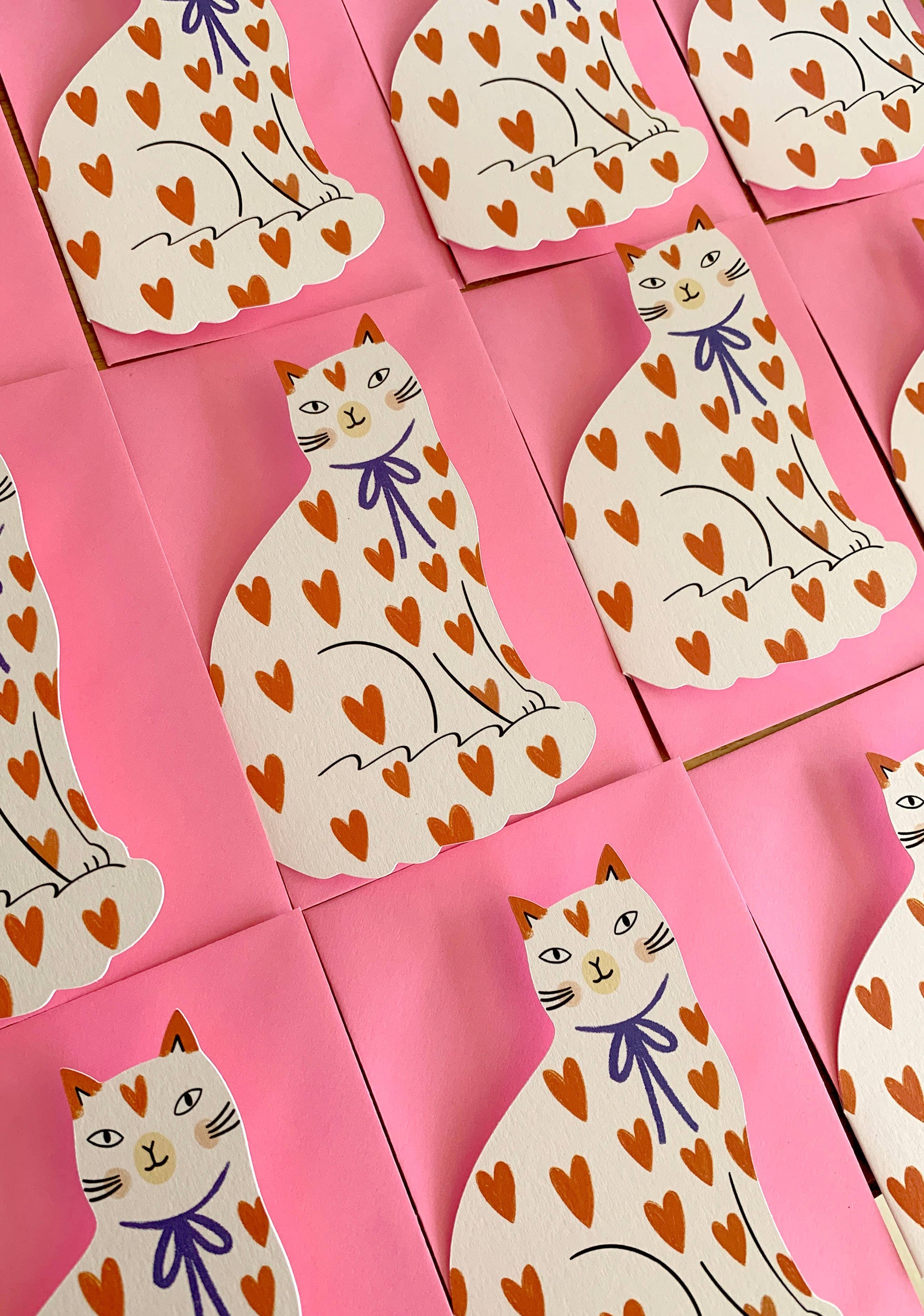Kitty Kenda shaped sitting cat greeting card with an orange heart-print pattern