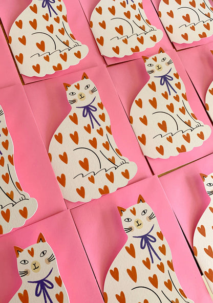 Kitty Kenda shaped sitting cat greeting card with an orange heart-print pattern