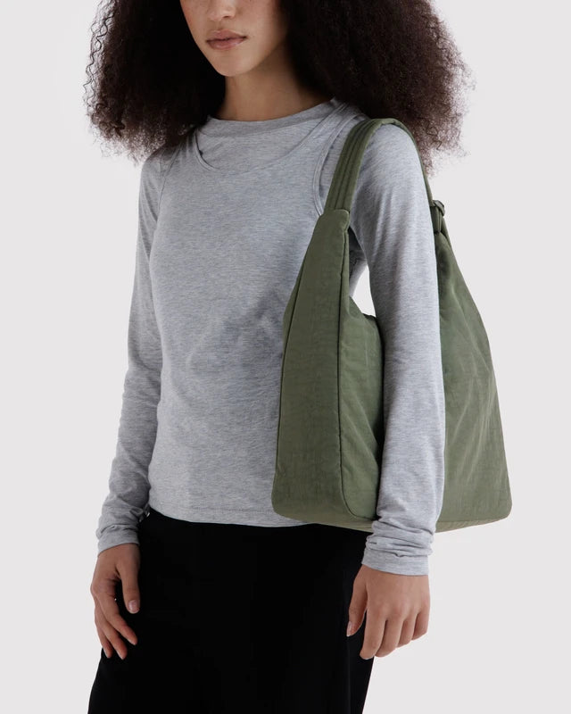 Interior view of the BAGGU Nylon Shoulder Bag in caper green showing the zip pocket