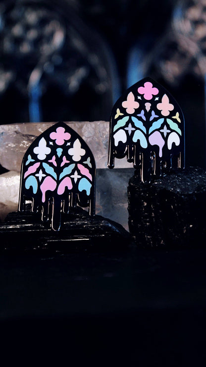 Trans Gothic Cathedral Window pin shown on a card backing for scale