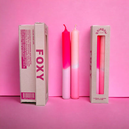 Rainbow Studio Dinner Candle Set Foxy — two dip-dyed taper candles in pink-to-white gradients, shown beside kraft packaging