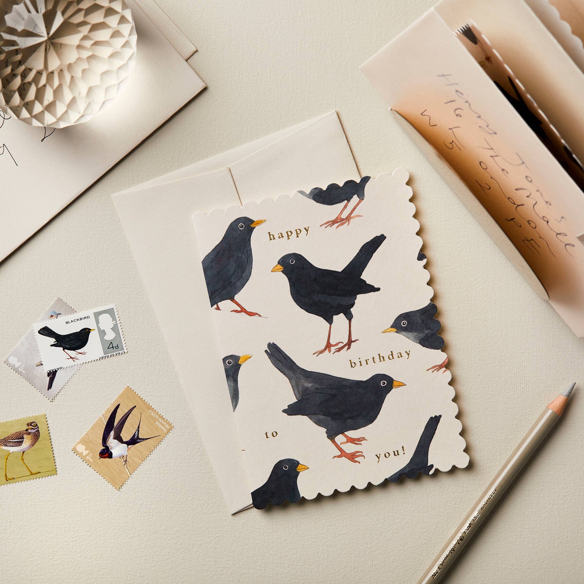 Pale grey card with a scattered watercolor blackbird pattern, reading Happy Birthday to You!