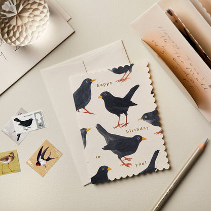 Pale grey card with a scattered watercolor blackbird pattern, reading Happy Birthday to You!