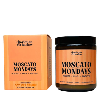 Charleston & Harlow Moscato Mondays soy candle in amber glass jar with peach striped label, beside its matching gift box