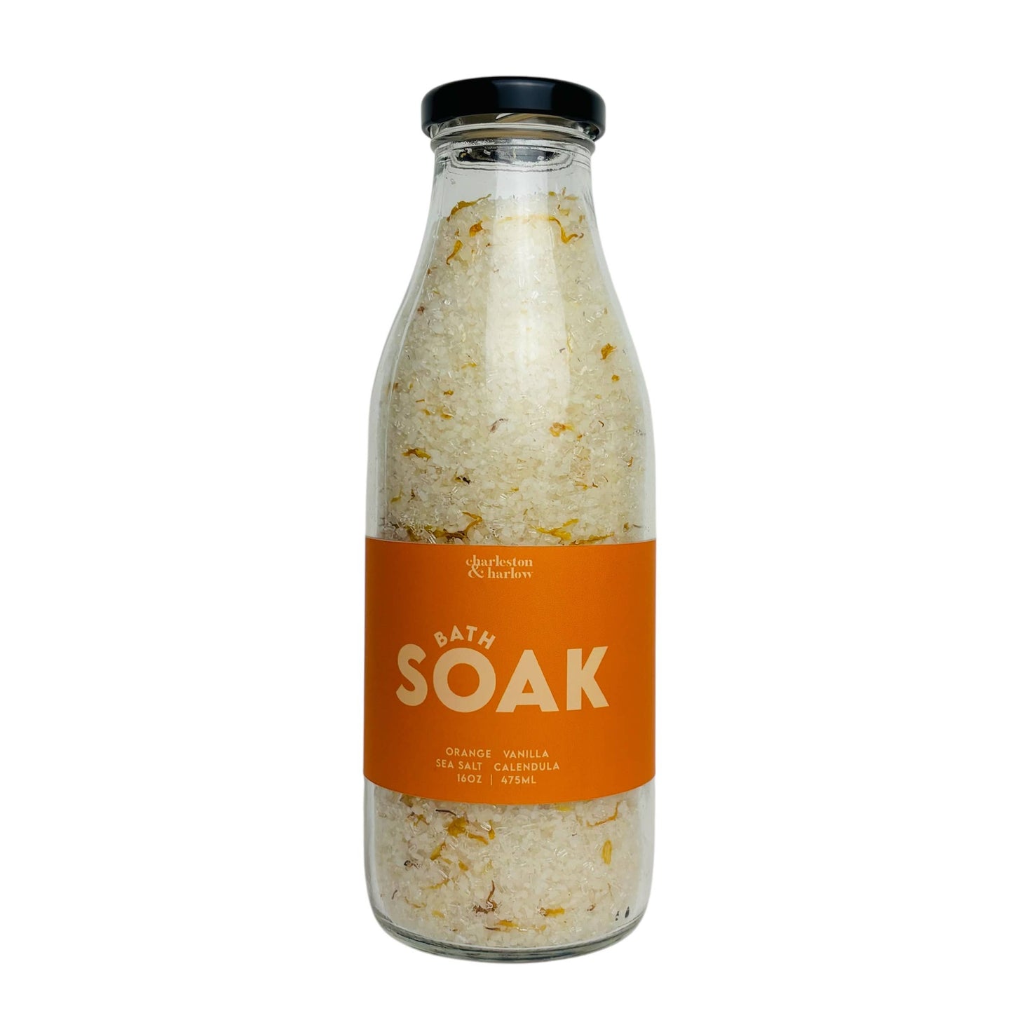 Glass bottle of Charleston & Harlow Bath Soak with orange label, sweet orange and calendula petal salt blend