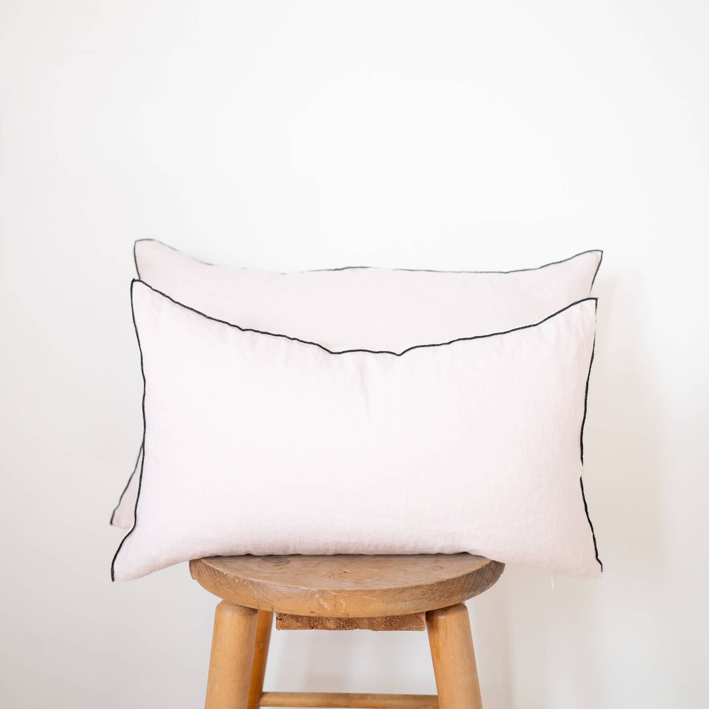 Back of the blush edged linen lumbar pillow cover showing the closure