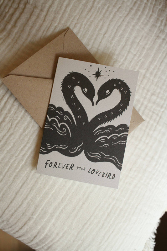 'Lovebirds' card with kraft envelope on a light background