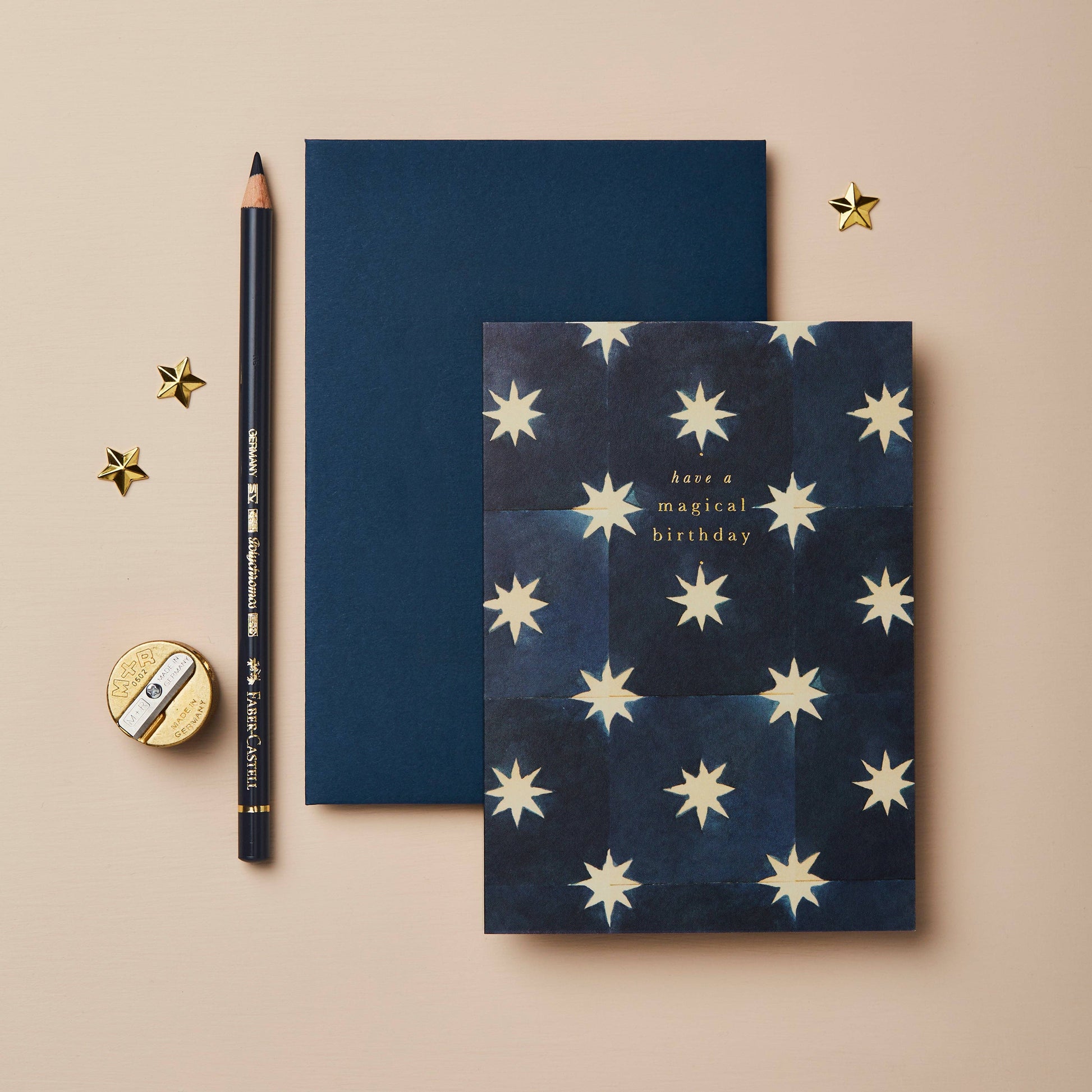 Navy blue card with a gold star tile pattern, reading Have a Magical Birthday