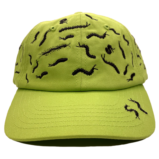 Acid green dad hat covered in black embroidered centipede designs scattered across the crown and brim, front view.
