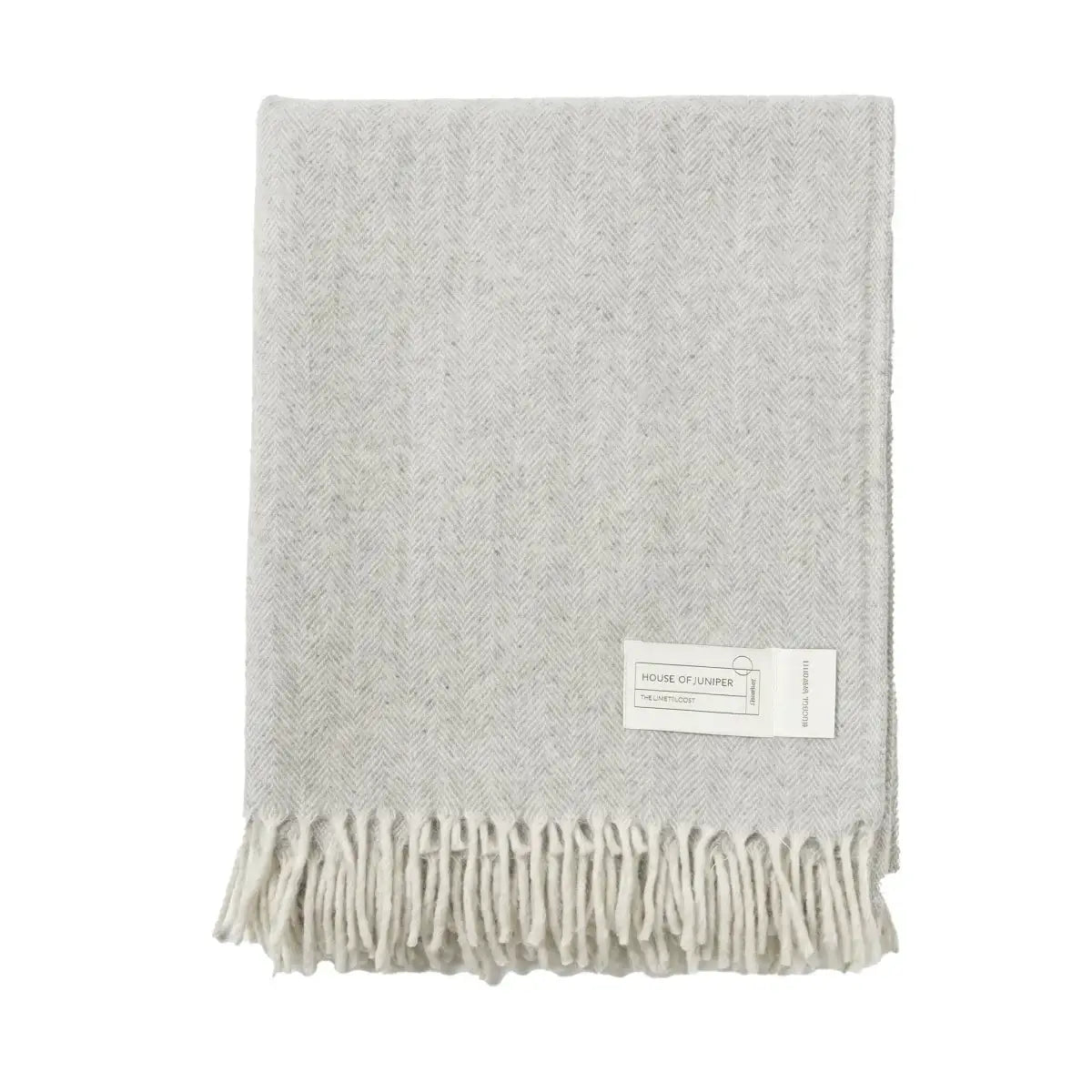 Grey herringbone wool throw folded to show fringe detail - PABOOM