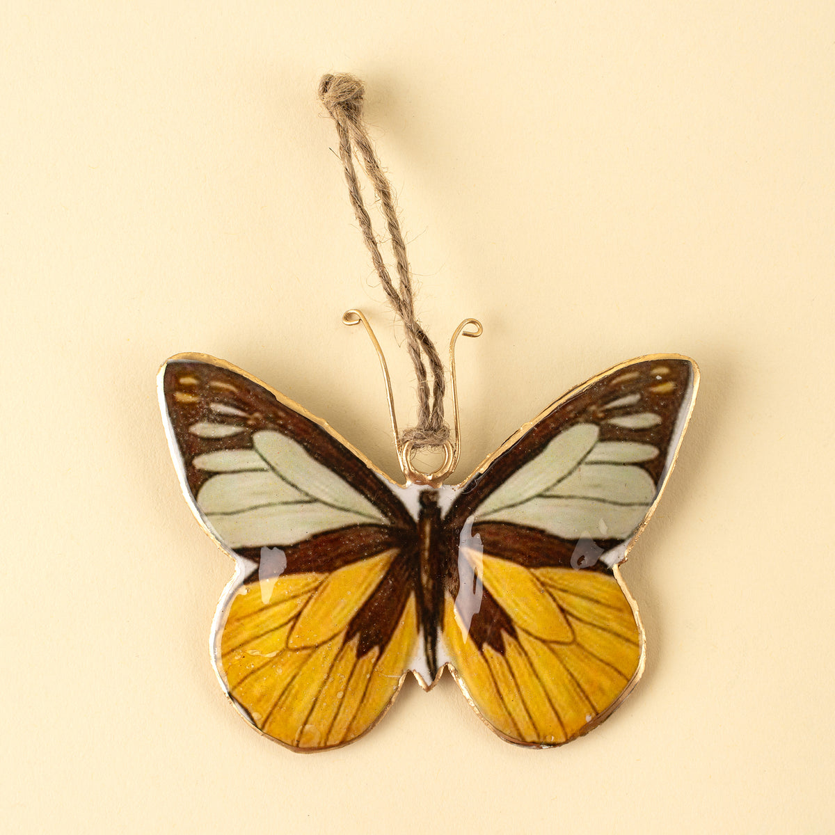 Keepsake Iron Ornament with amber and black butterfly print on a white background - PABOOM
