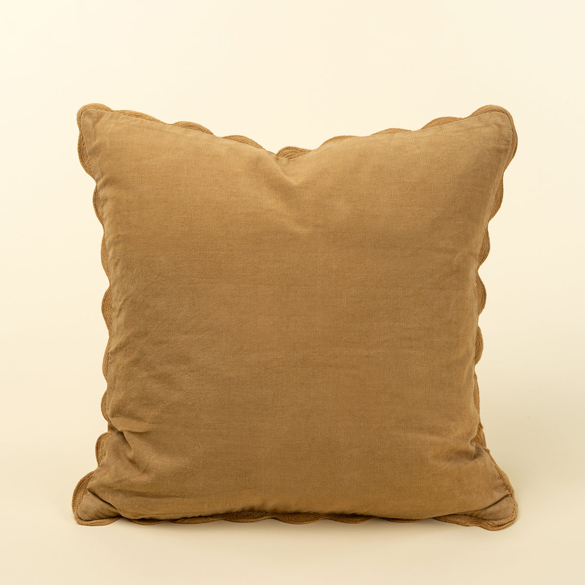Solid warm gold corduroy pillow with a tone-on-tone scalloped edge